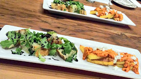 Oso Market + Bar appetizer of Cremeux Montadito with fig, honey, arugula and balsamic reduction served on Little T focaccia and Ratatouille atop crispy polenta 