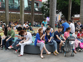 people sitting at a small park in Dongmen