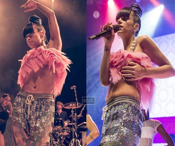 Liliy Allen risked an embarrassing wardrobe malfunction and was forced to grab her breast to avoid such a mishap. The singer bares naked midriff and almost too much cleavage in eccentric pink and silver outfit at London album launch.