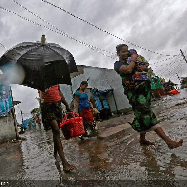 A woman carries her baby as she moves to a safer place with others at the village Donkuru in Srikakulam district in the southern Indian state of Andhra Pradesh.