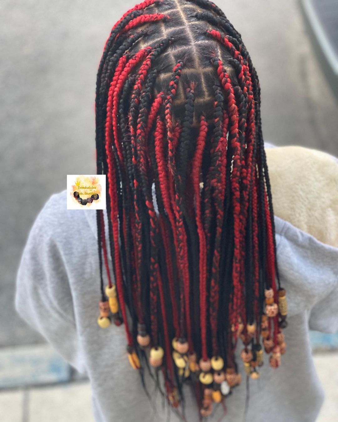 38. Black And Red Center Part Knotless Braids With Brown Beads