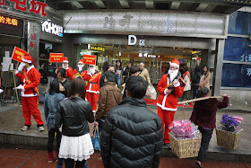 several young men dressed up as Santa Claus for a promotion at a shopping center in Changsha, China