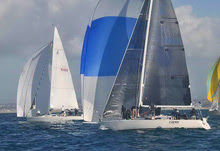 J/120 sailboat- sailing under spinnaker to next sailing course mark