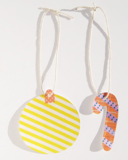 Cut out some Christmas shapes out of patterned paper, photocopy them onto cardboard, punch a hole at the top and finish with some string. Cut out some Christmas shapes out of patterned paper, photocopy them onto cardboard, punch a hole at the top and finish with some string.