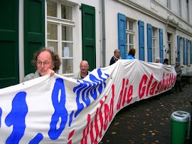 Protestierende mit Transparent zum Thema Glashütte.