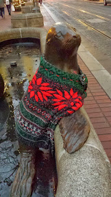 #UglySweaterPDX campaign, 2013: Some of downtown’s most iconic sculptures will don their holiday finery for the season. In the Pioneer District on Southwest Yamhill and Morrison streets (between Fifth and Sixth avenues), you’ll see Animals in Pools, Allow Me (aka “Umbrella man”) and Kvinneakt dressed up in festive ugly sweaters.