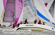 J/109 one-design sailboats- sailing downwind under spinnaker