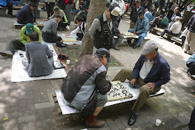 two men playing baduk (Go) at a park in Seoul