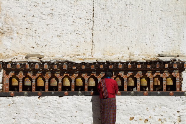 Buddhist Woman prays at a temple in Trongsa Dzong, Bhutan