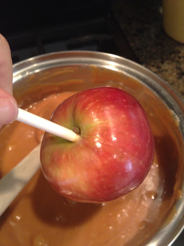 Dipping apples in caramel