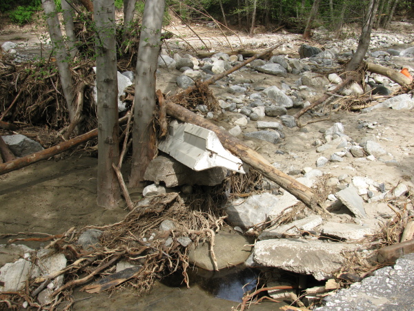 A concrete barrier washed up in the flood plane.