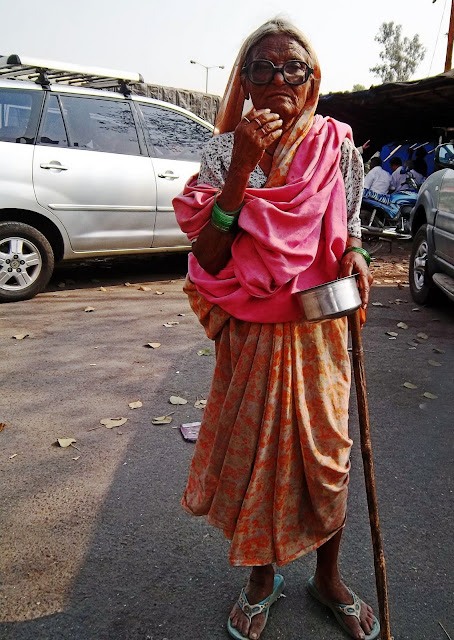 old beggar woman outside MacDonalds