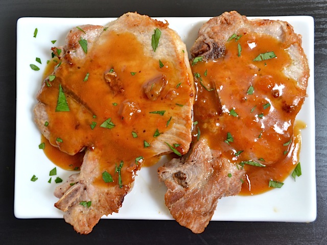 top view of two Apricot Dijon Pork Chops on white plate 