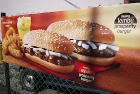 advertisement on a chain linked fence for McDonald's prosperity burger in Penang, Malaysia