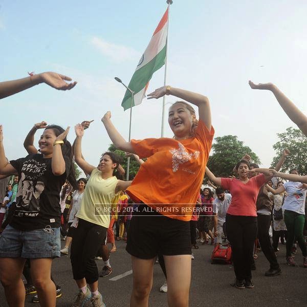 People dance during the Raahgiri Day, held at Connaught Place. 