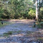 Open sandy area numbered campsites