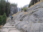 Series of steps along Mist Trail. Vernal Falls in the background.