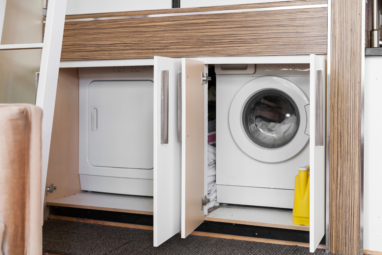 Store laundry machines below the loft bed