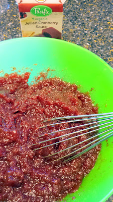 Non-alcoholic Cranberry Ginger Ale Punch Recipe: Pacific Organic Jellied Cranberry Sauce being whisked from the rectangular shape of the package to be more freeform