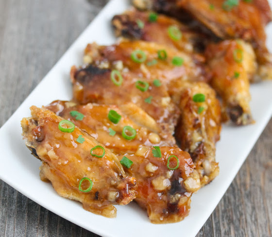 close-up photo of wings garnished with scallions