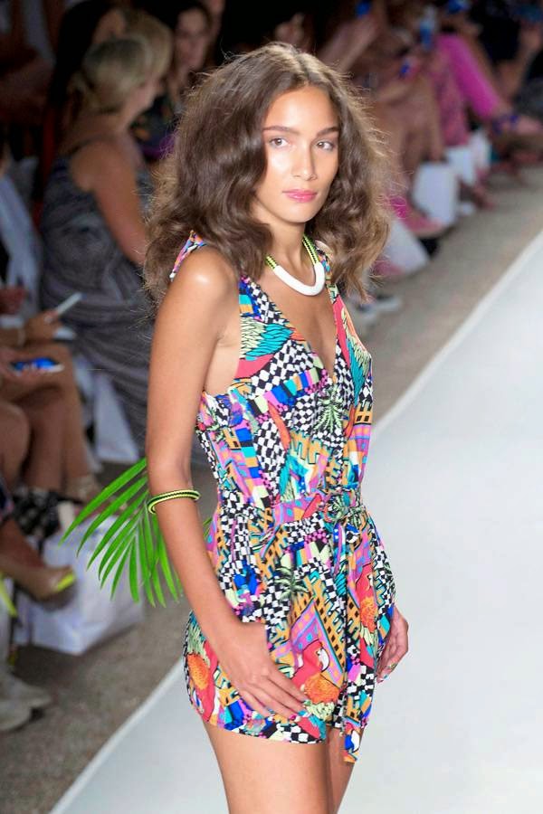 A model poses on the runway wearing swimwear from the Mara Hoffman Swim collection during the Mercedes-Benz Fashion Week Swim show, Saturday, July 19, 2014, in Miami Beach, Florida.