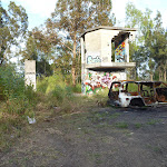 Derelict buildings and a burnt out car at the end of Belmont Lagoon (390389)
