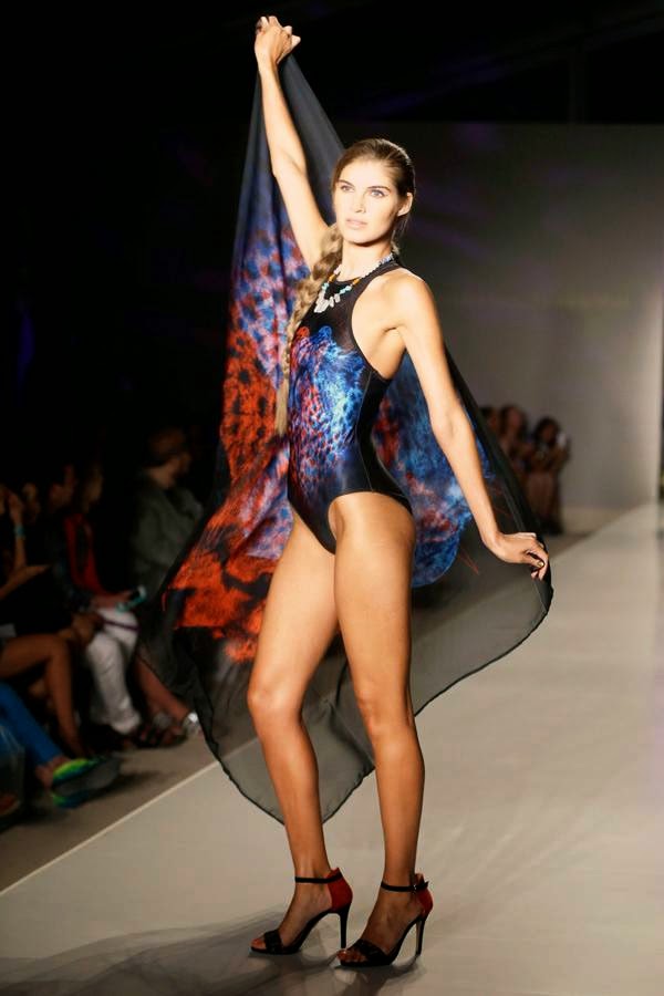 A model walks down the runway wearing swimwear designed by We Are Handsome during the Mercedes-Benz Fashion Week Swim show, Friday, July 18, 2014, in Miami Beach, Florida.