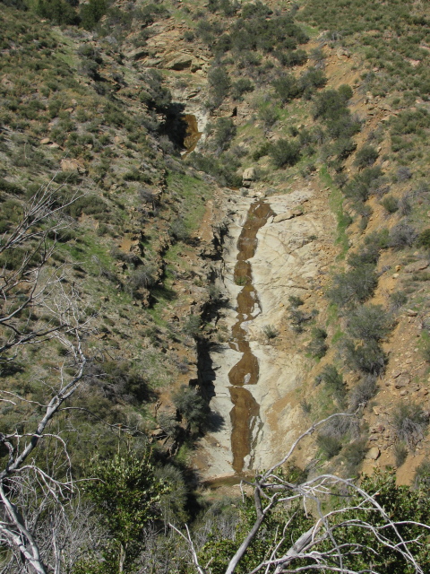 a rippling bit of rock with water coming down it