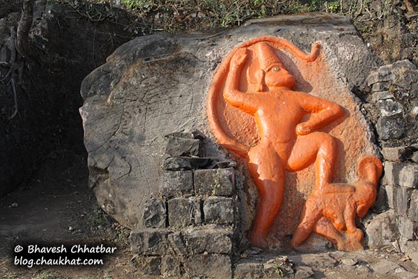 Stone carving of Hanuman on the trek of Tikona fort