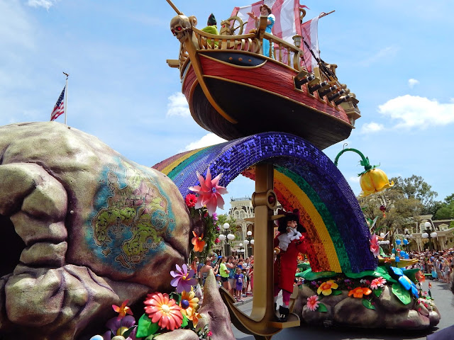 New Disney World Parade: Festival of Fantasy. Peter Pan and Wendy fly over a rainbow in their ex-pirate ship, fueled by Pixie dust, while Captain Hook swims on an anchor beneath.
