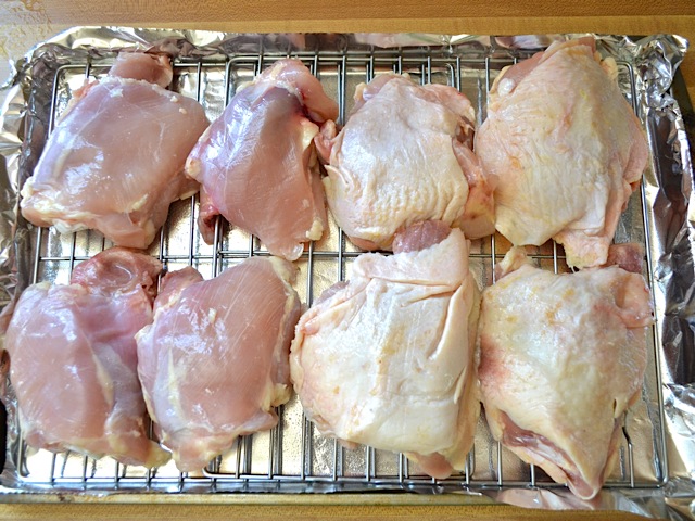 raw chicken thighs on roasting pan 