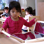 LePort Montessori Preschool Toddler Program Huntington Pier - girl observing herself at the mirror