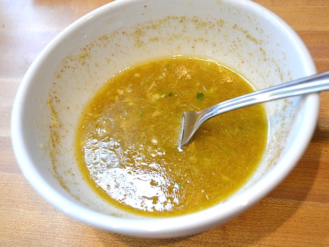 cumin dressing stirred in bowl with fork 