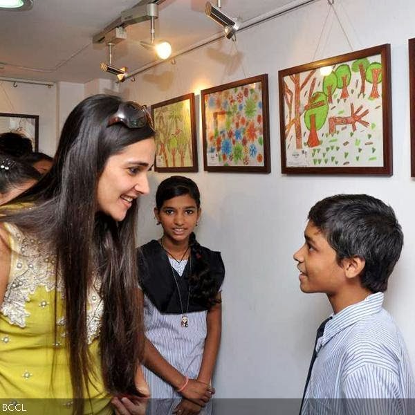 Tara Sharma communicates with children at the launch of a painiting exhibition, held in Mumbai, on October 9, 2013. (Pic: Viral Bhayani)
