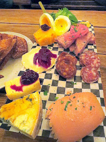 Brewstillery Festival preview of the StormBreaker Smorgasboard, a Cheese Plate combined with their Meat Plate that includes Olympic Provisions Selection meats and mousse and sliced bread that adds a soft boiled egg and simple salad, all for $14