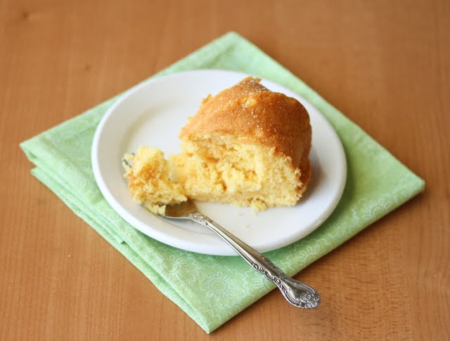 a slice of Eggless Custard Cake on a plate with a fork