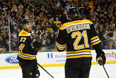 Patrice Bergeron #37 and Loui Eriksson #21 of the Boston Bruins celebrate a goal against the Toronto Maple Leafs