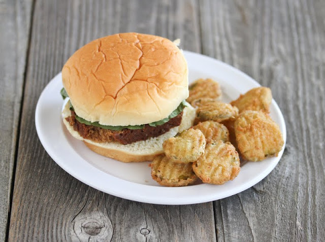 photo of a burger with a side of fried pickles