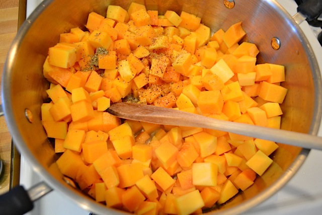 squash and seasoning added to pot and stirred with wooden spoon 