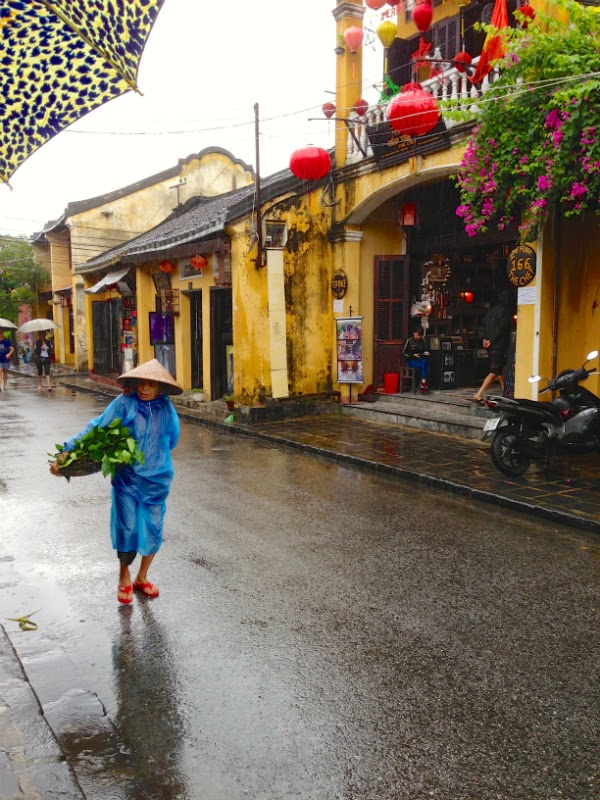 hoi an ladies fruit streets rain ancient town