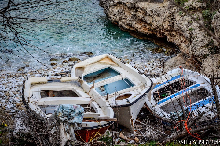 Moored boats on a rocky shore. Exploring the Mani, Southern Peloponnese, Greece