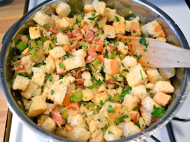 bread cubes and parsley added to pot of other ingredients 
