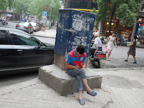 man looking at his mobile phone in Hengyang, Hunan, China