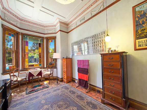 The gothic coloured glass panels are typically Federation Queen Anne style, and so is the ceiling. However the wreath patterns are a hang-over from Victorian celebratory excess.