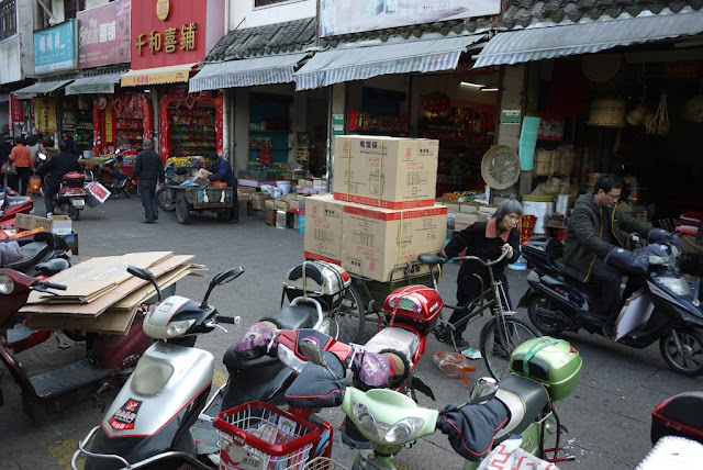 woman pushing a tricycle cart at Xiaoshan Street in Shaoxing, China