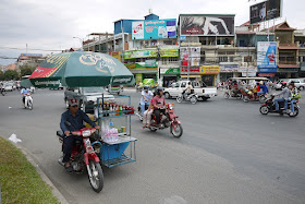 man riding motorbike with mobile drink cart