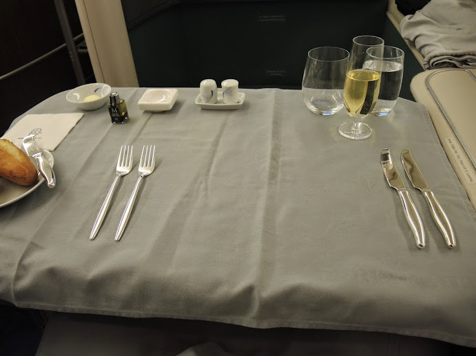 a table with silverware and glasses on it