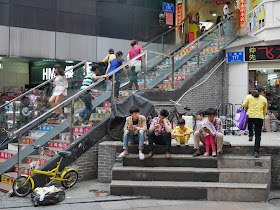 people sitting on steps at Dongmen
