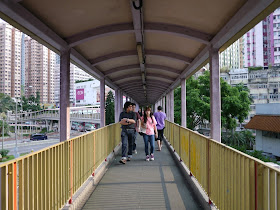 people walking on an elevated walkway in Tsuen Wan, Hong Kong