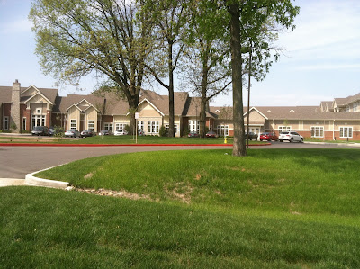 retirement,home,hill,green,grass,trees,parking